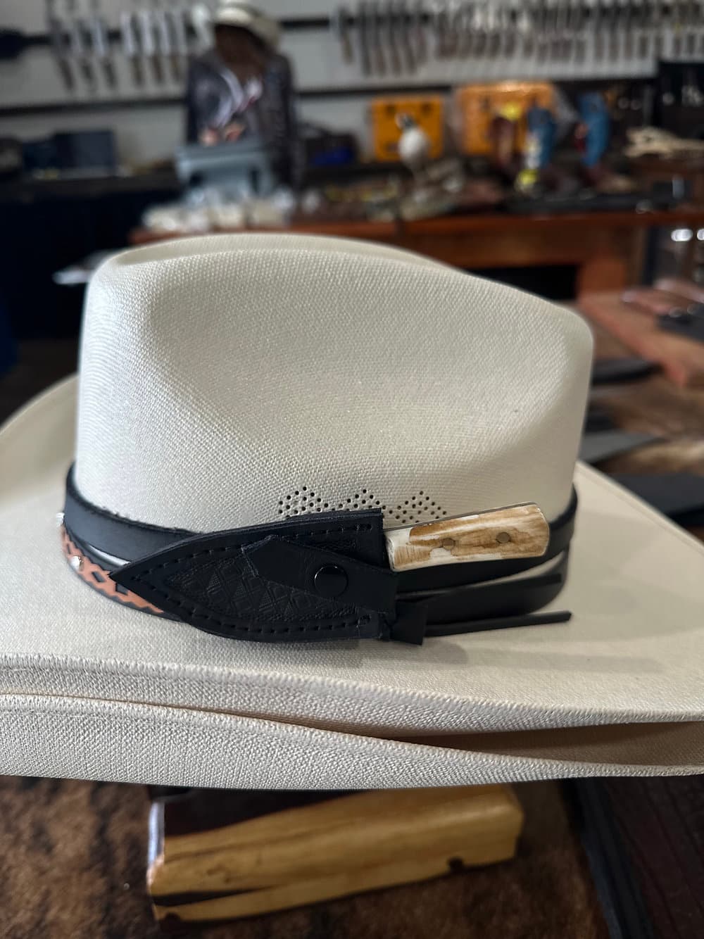 A hand-forged hat knife resting on the workbench at Villarreal Knives Edinburg